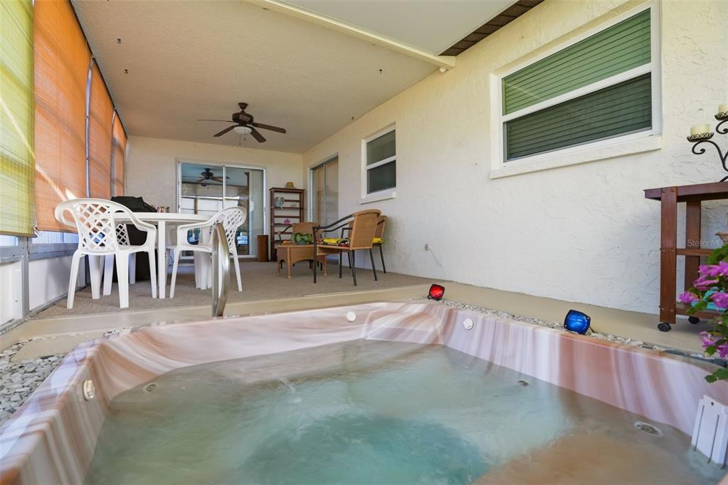 7329 Cay Drive Port Richey, FL 34668 - Photo 32 of 38 a living room with furniture a dining table and a flat screen tv