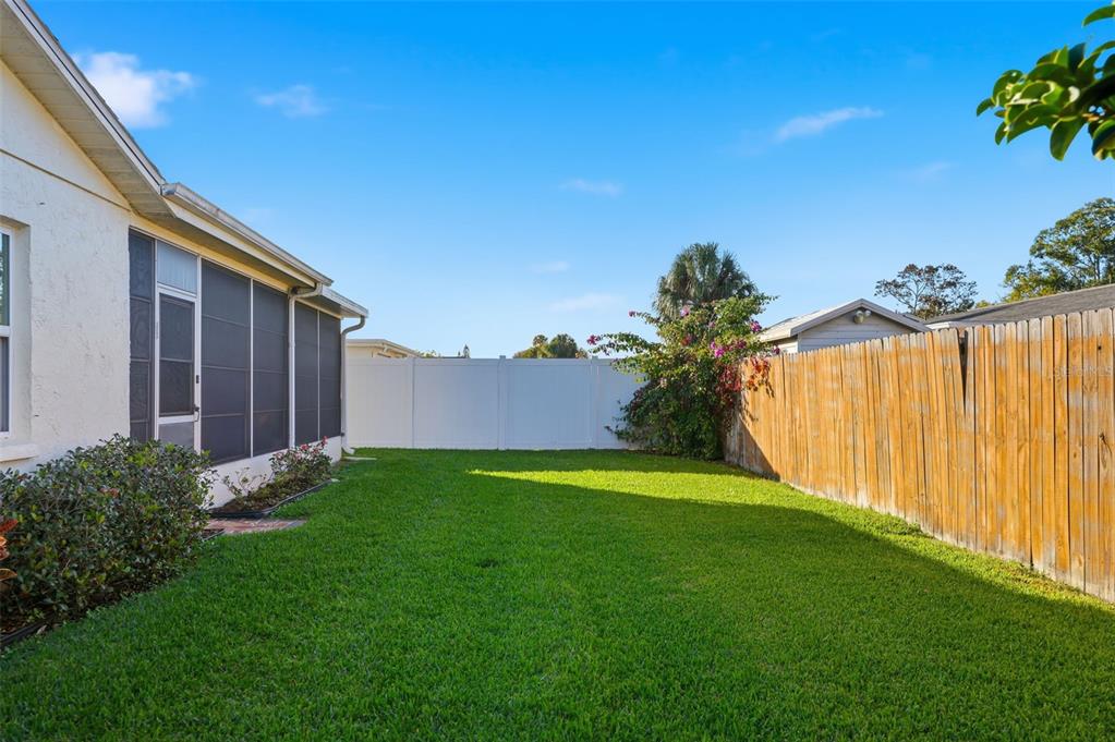 7329 Cay Drive Port Richey, FL 34668 - Photo 35 of 38 a backyard of a house with lots of green space and outdoor seating