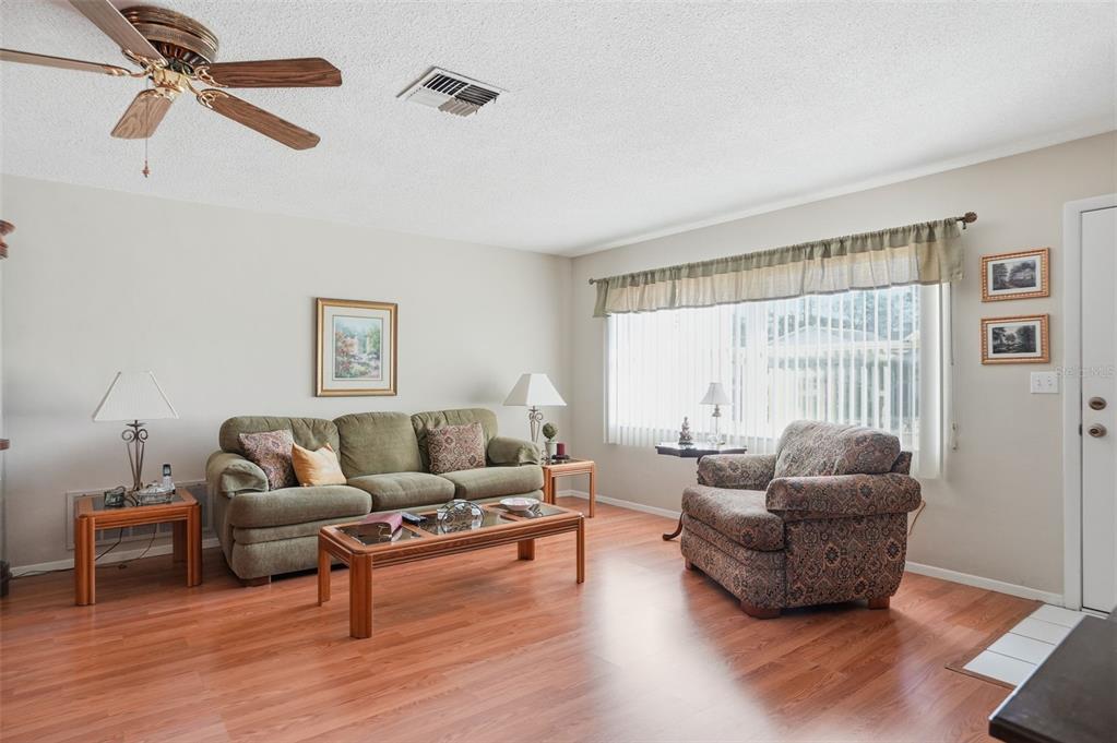 7329 Cay Drive Port Richey, FL 34668 - Photo 4 of 38 a living room with furniture and a large window