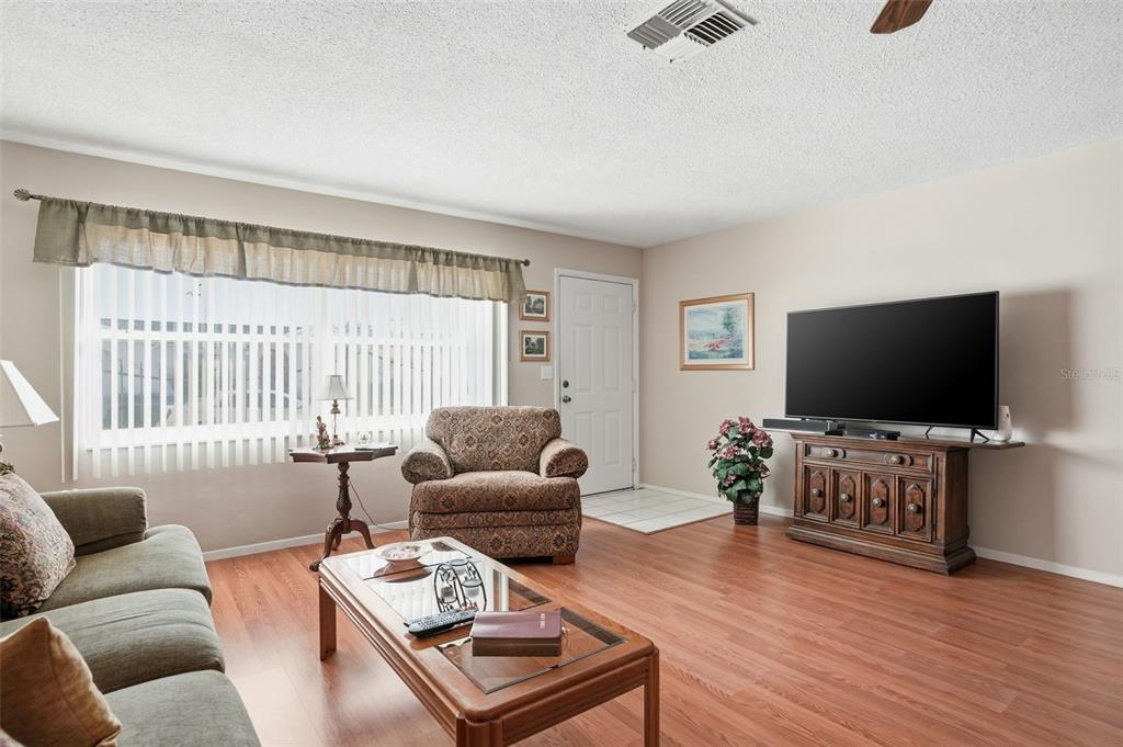 7329 Cay Drive Port Richey, FL 34668 - Photo 7 of 38 a living room with furniture and a flat screen tv