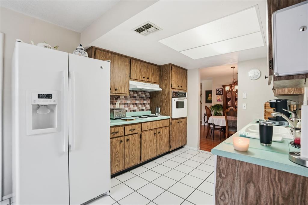 7329 Cay Drive Port Richey, FL 34668 - Photo 10 of 38 a kitchen with stainless steel appliances a sink and refrigerator