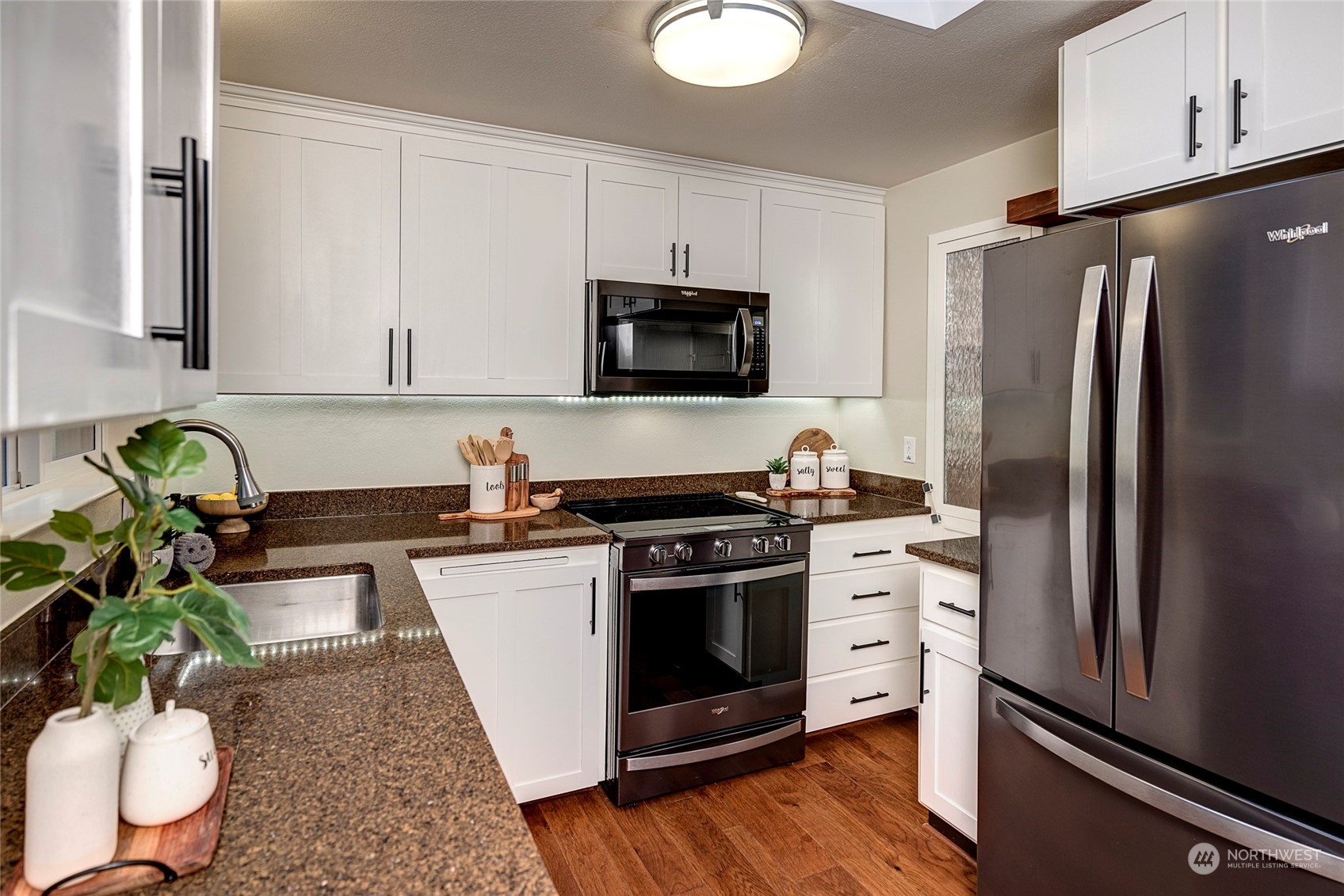 3405 197th Place Southeast Bothell, WA 98012 - Photo 4 of 17 a kitchen with stainless steel appliances a stove a sink and a refrigerator