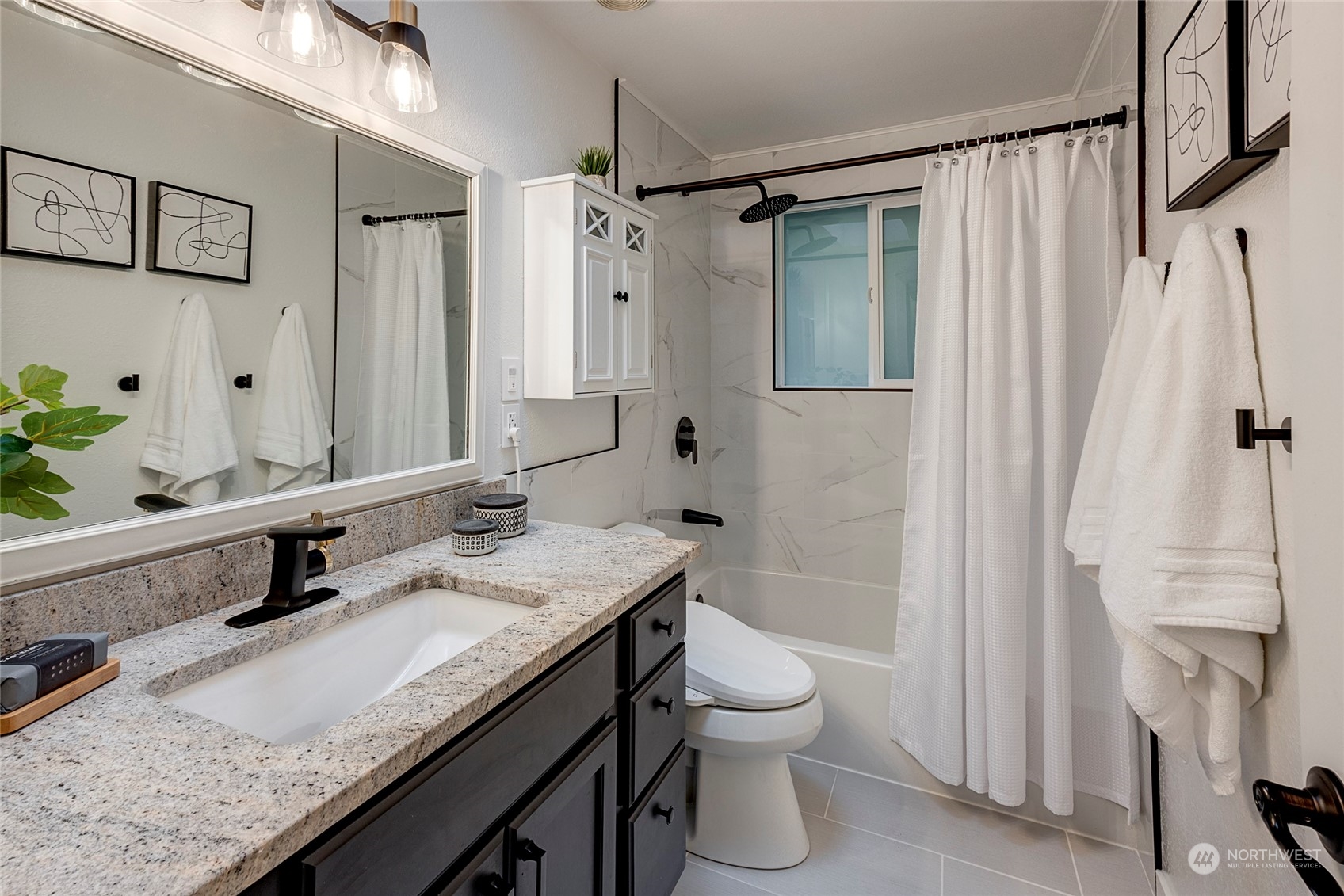 3405 197th Place Southeast Bothell, WA 98012 - Photo 5 of 17 a bathroom with a granite countertop sink a toilet and shower