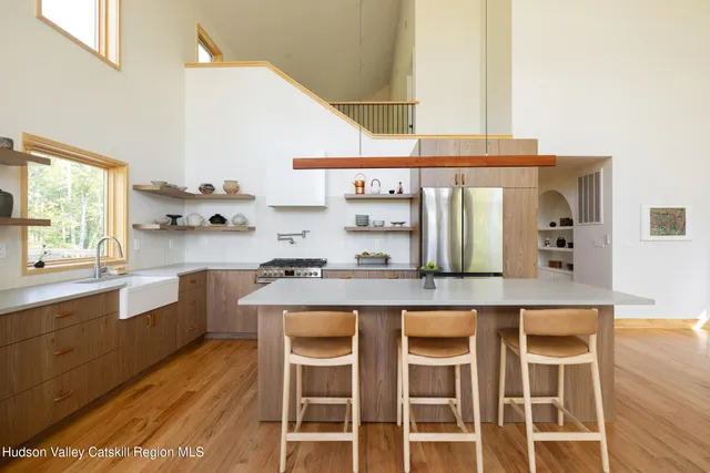 a large bed sitting in a bedroom next to a window