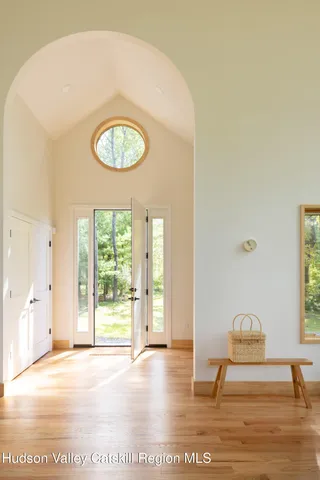 a bedroom with a bed and a large window