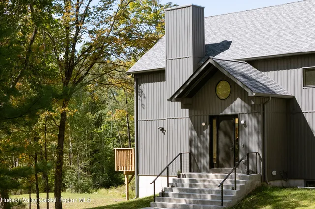 a living room with furniture and floor to ceiling windows