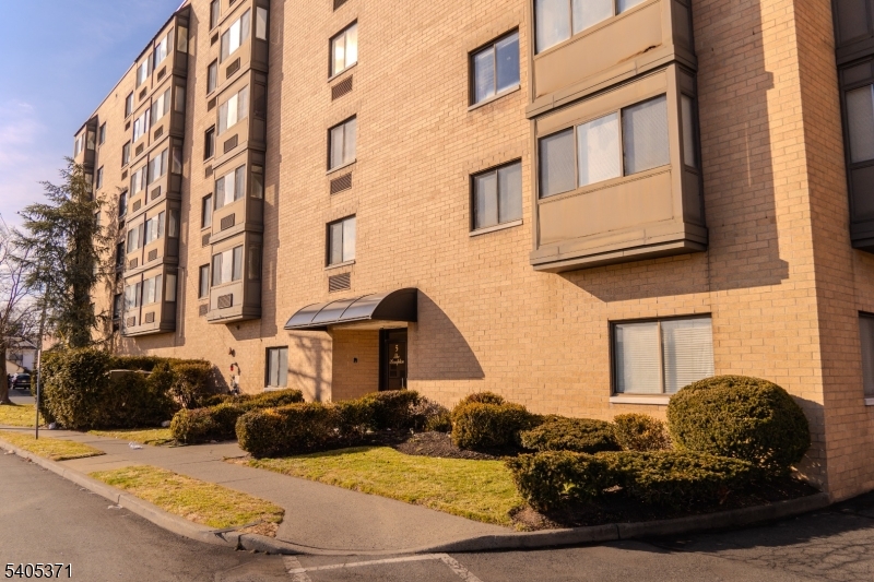 a view of a brick house with many windows