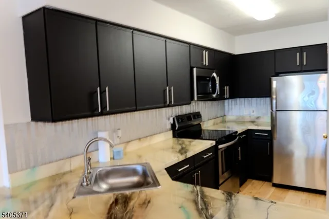 a kitchen with a sink stove and refrigerator