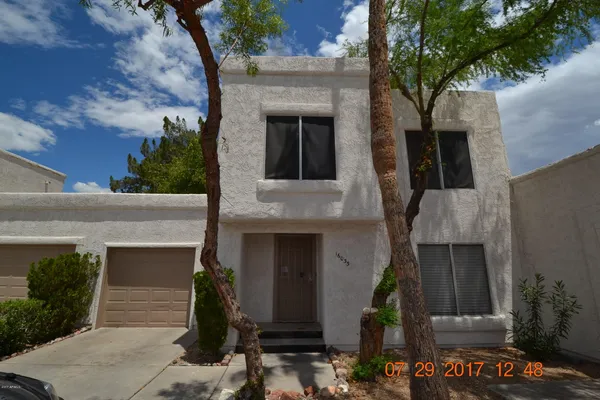 front view of a house with a tree
