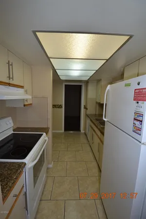 a kitchen with a refrigerator and cabinets