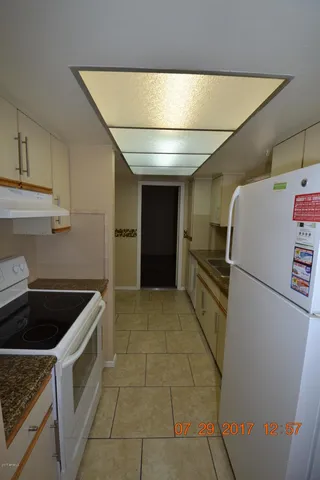a kitchen with a refrigerator and cabinets