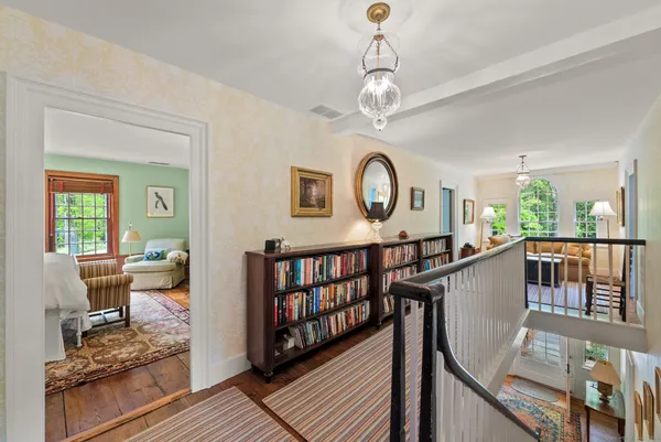 a view of a livingroom with furniture wooden floor and a clock