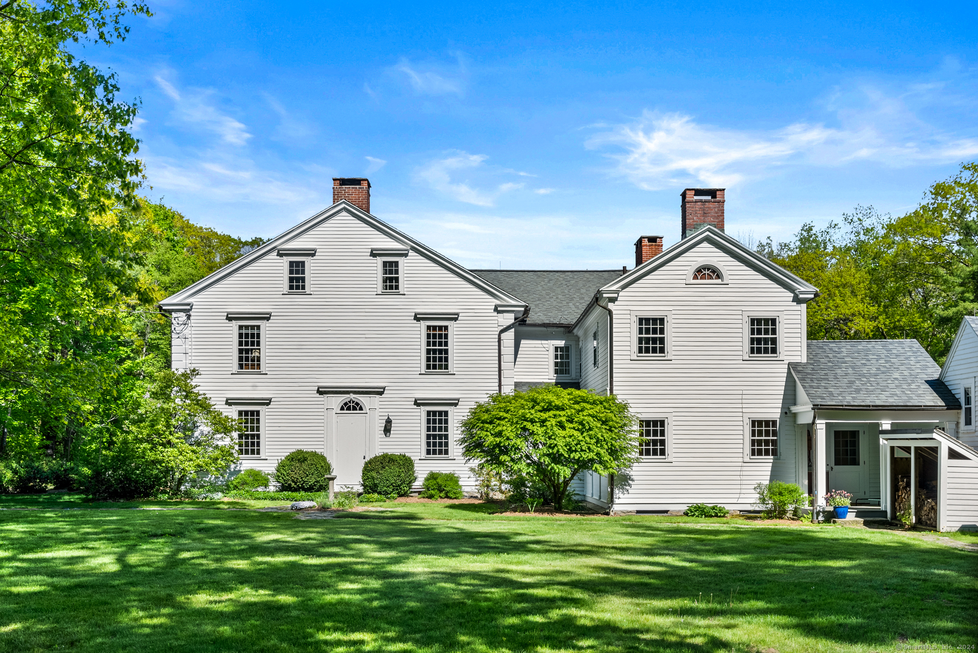 210 Doolittle Drive Norfolk, CT 06058 - Photo 33 of 40 a view of a white house with a big yard and potted plants in front of a house