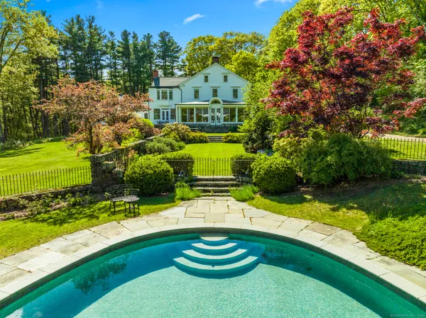 a swimming pool with trees in the background