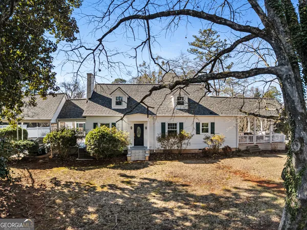 a front view of a house with a yard covered with snow