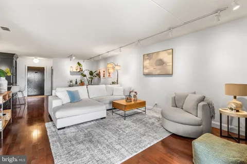 a living room with furniture and wooden floor