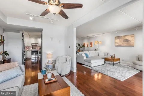 a living room with furniture and a chandelier