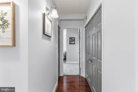 a view of a hallway with wooden floor and staircase