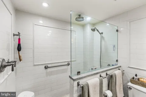 a bathroom with a shower and a mirror