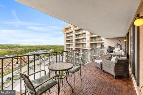 a balcony with table and chairs