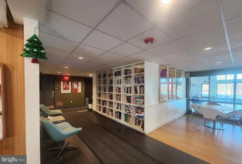 a living room with furniture and a book shelf