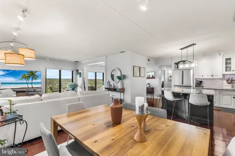 a dining room with furniture and wooden floor