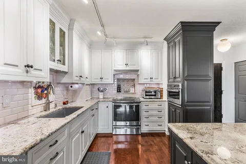 a kitchen with a sink stove and refrigerator