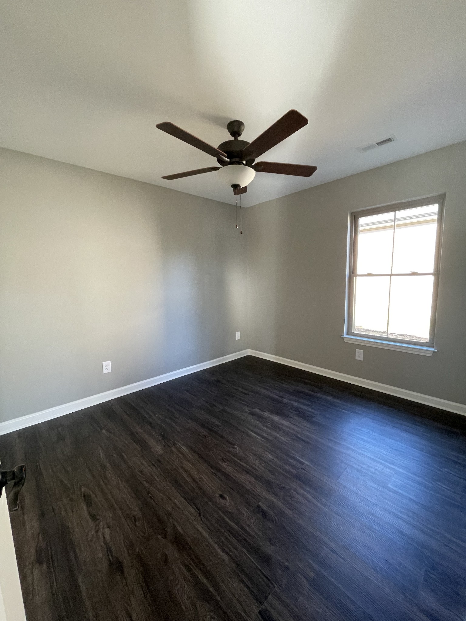128 Eno Road Dickson, TN 37055 - Photo 10 of 12 an empty room with wooden floor fan and windows