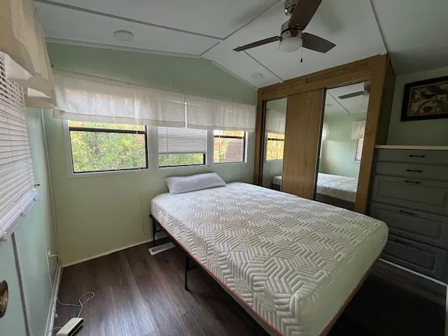 a bedroom with a bed and lamp on desk