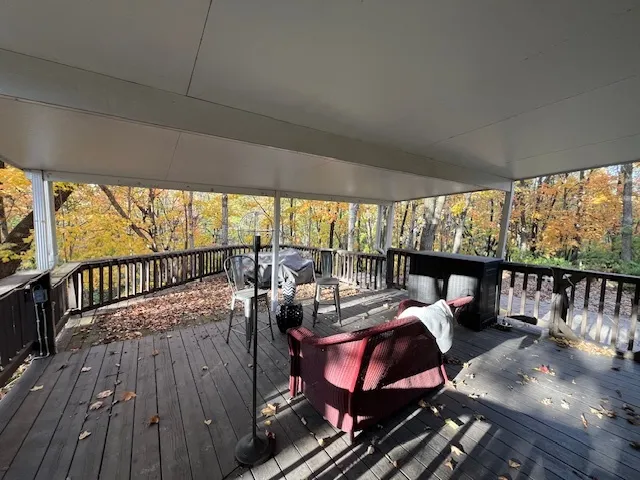 a balcony with furniture and wooden floor