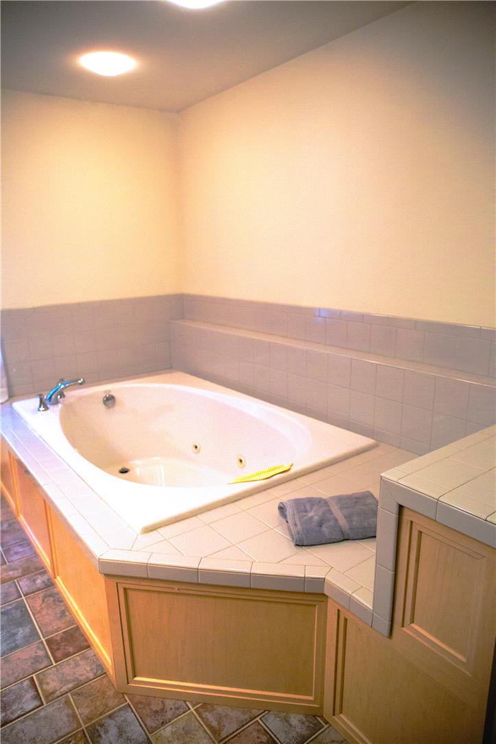 50 Anthony's Road White Haven, PA 18661 - Photo 38 of 57 An inviting corner soaking tub with jetted features promises relaxation after a long day.