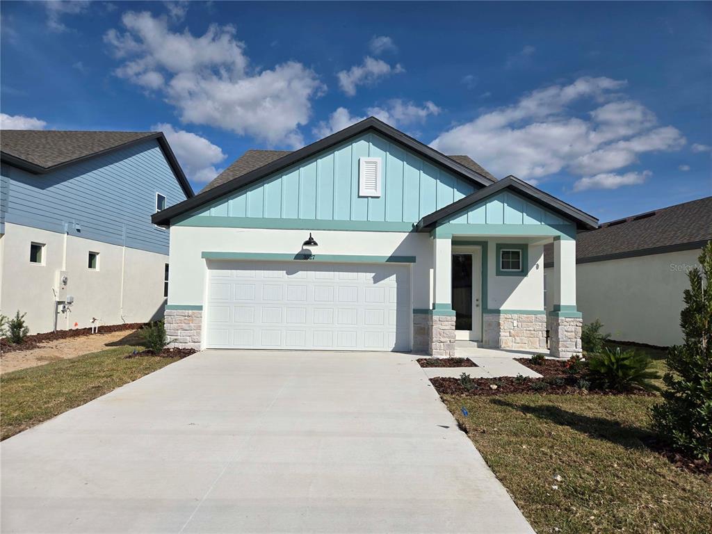 3827 Daybreak Run Loop Spring Hill, FL 34609 - Photo 1 of 14 a front view of a house with a yard