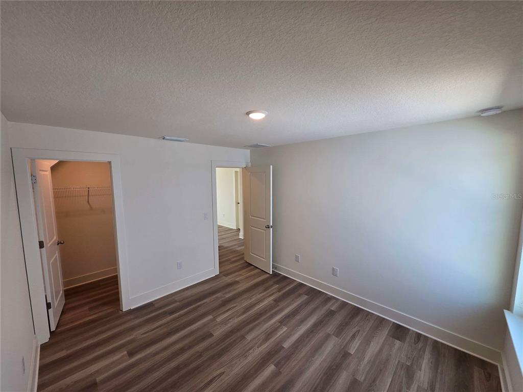 3827 Daybreak Run Loop Spring Hill, FL 34609 - Photo 12 of 14 wooden floor in an empty room