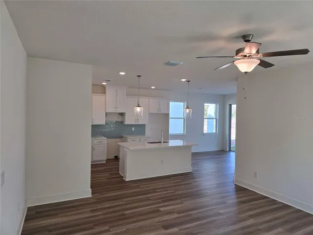 a view of kitchen with sink and wooden floor
