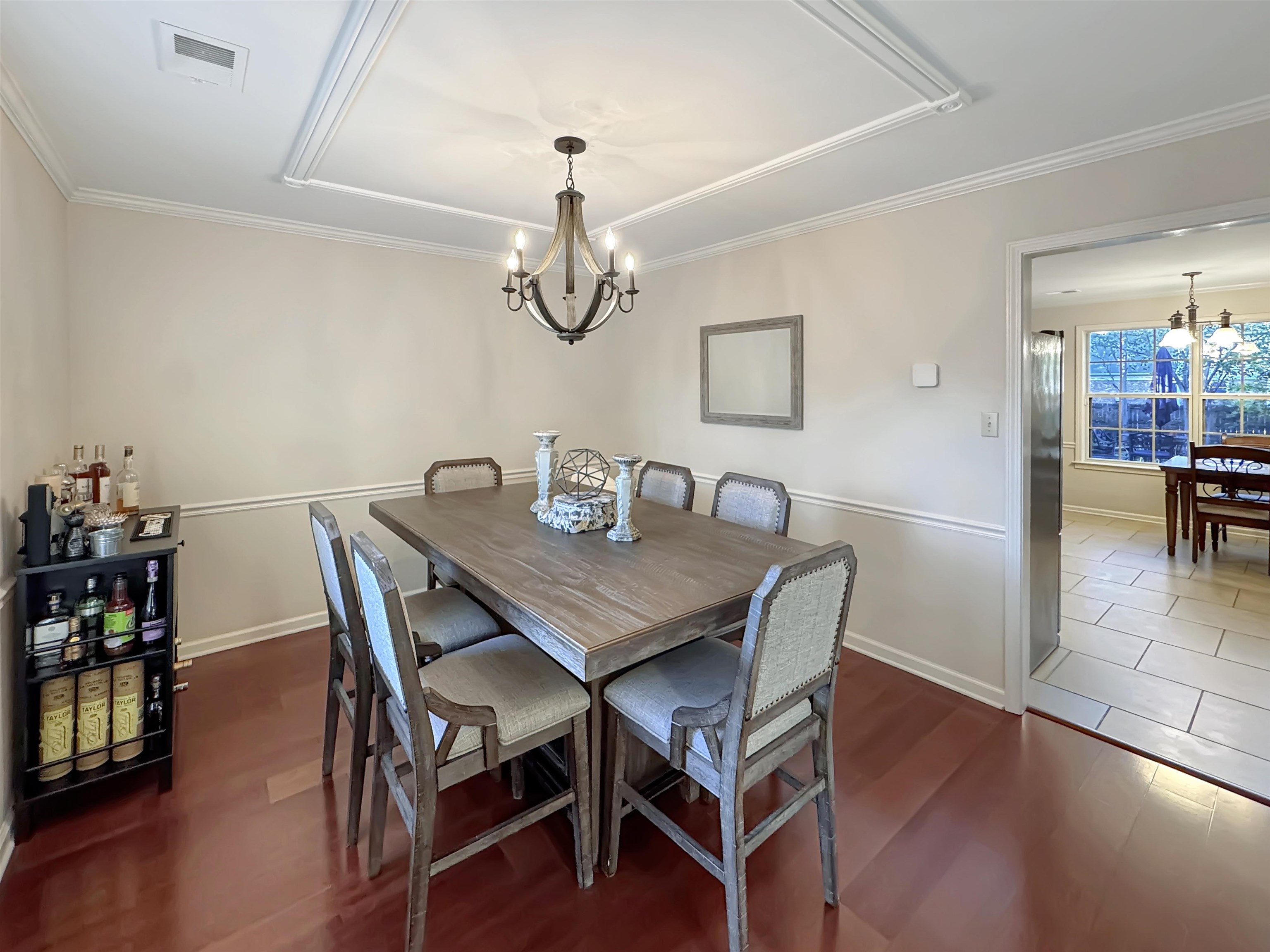 340 Scarlett's Way Collierville, TN 38017 - Photo 16 of 40 Dining area featuring a chandelier, dark wood-style flooring, and ornamental molding
