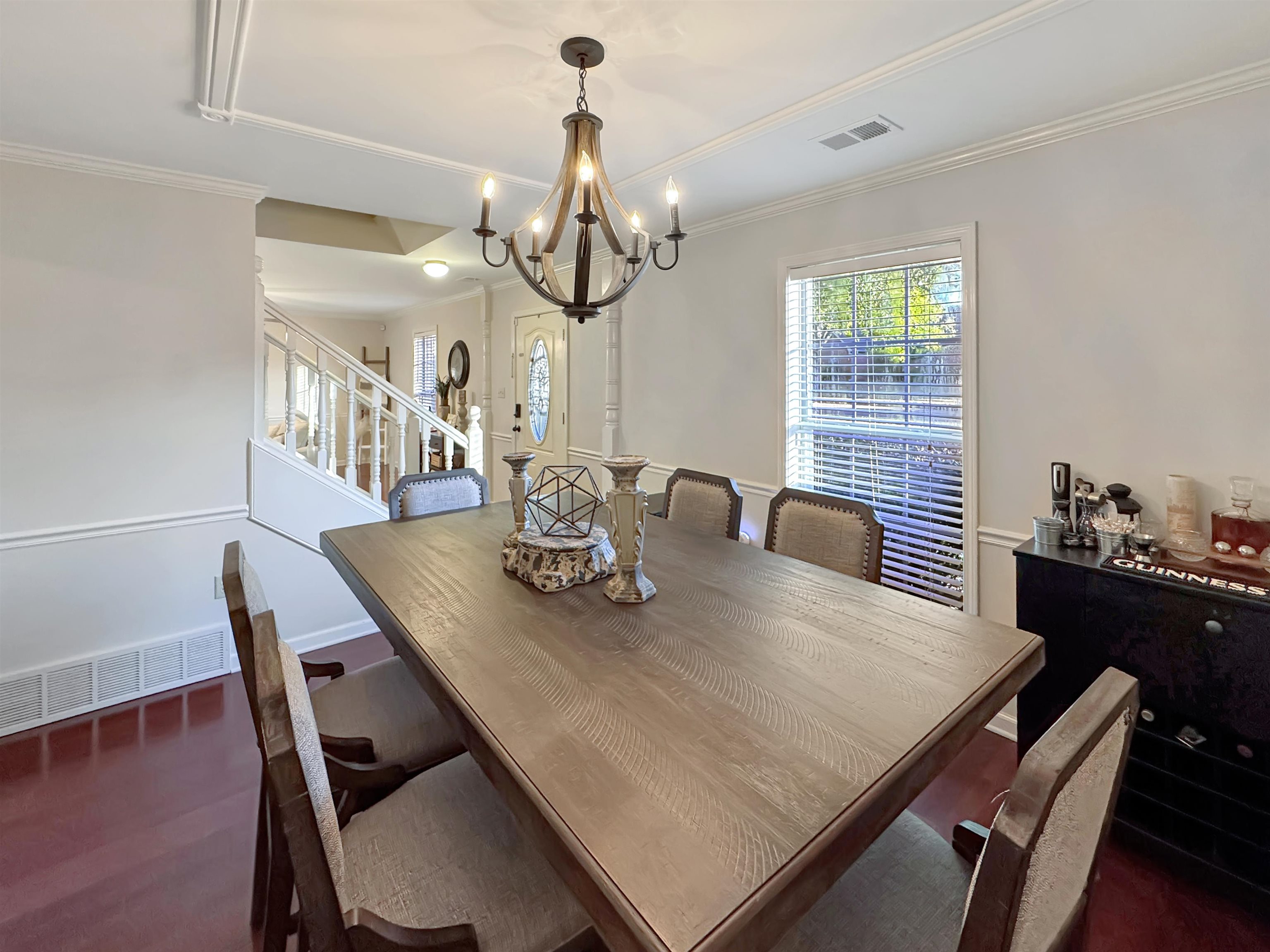 340 Scarlett's Way Collierville, TN 38017 - Photo 18 of 40 Dining area featuring ornamental molding, stairway, a chandelier, and dark wood-type flooring