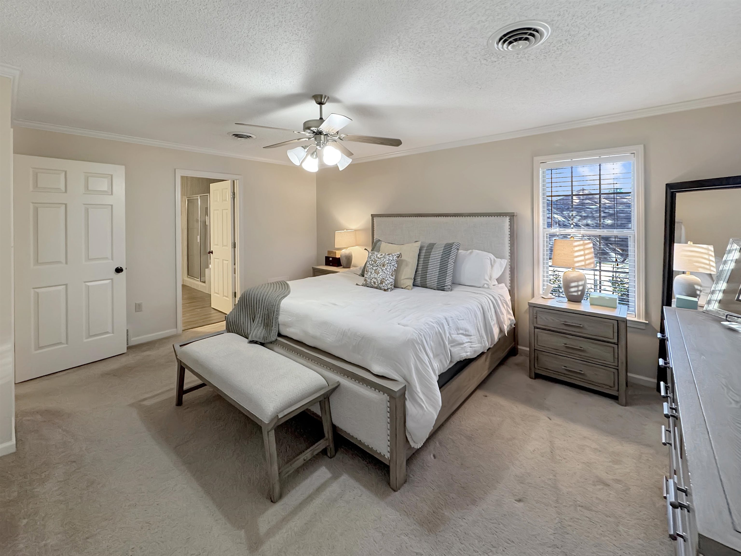 340 Scarlett's Way Collierville, TN 38017 - Photo 22 of 40 Bedroom with crown molding, a textured ceiling, light colored carpet, a ceiling fan, and ensuite bath