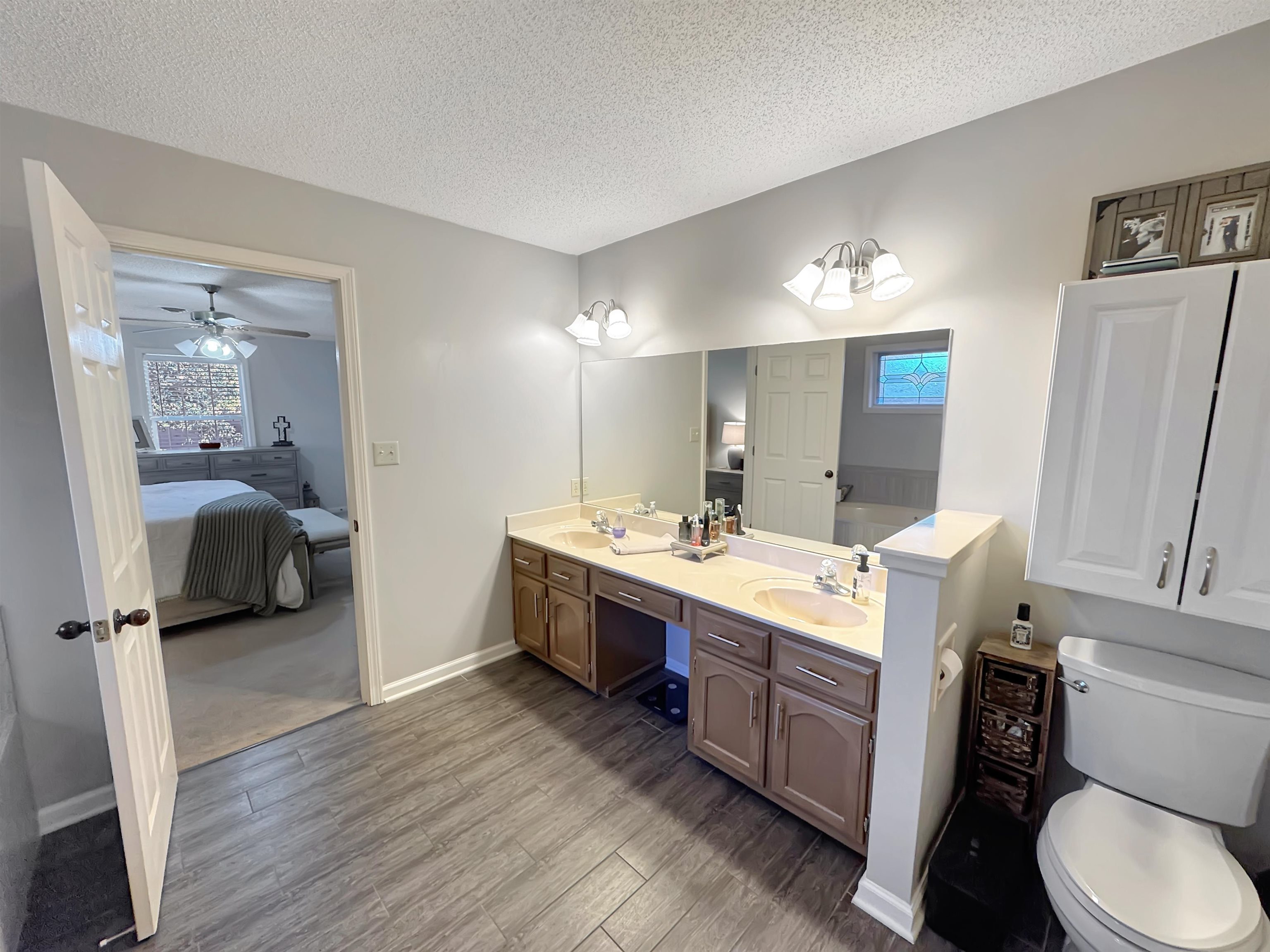 340 Scarlett's Way Collierville, TN 38017 - Photo 27 of 40 Full bath featuring ensuite bath, a textured ceiling, double vanity, dark wood finished floors, and a bath