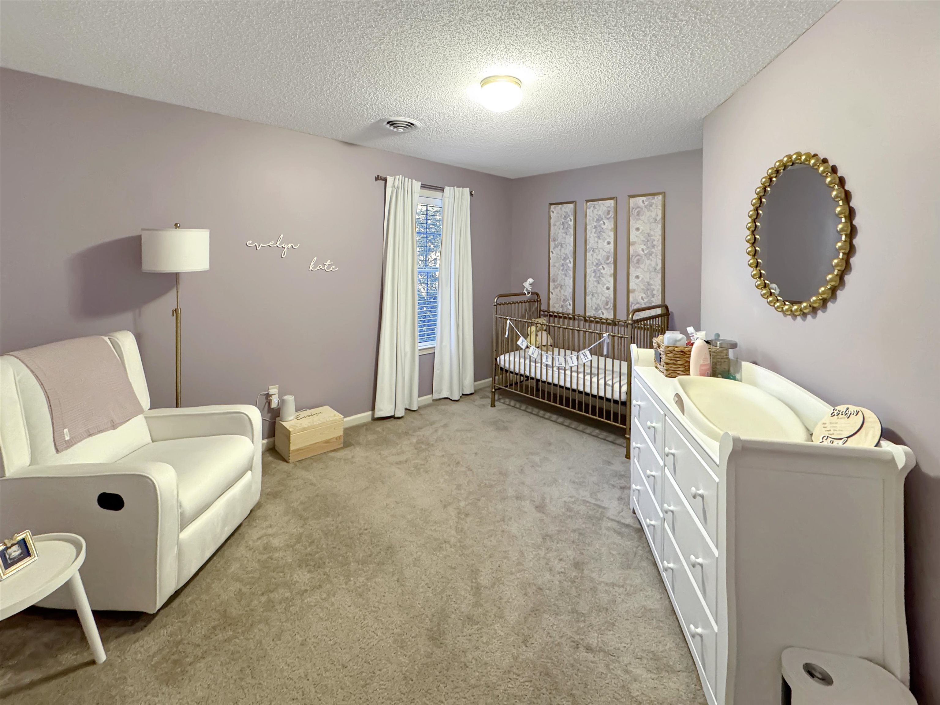 340 Scarlett's Way Collierville, TN 38017 - Photo 28 of 40 Bedroom with light colored carpet, a textured ceiling, and a nursery area