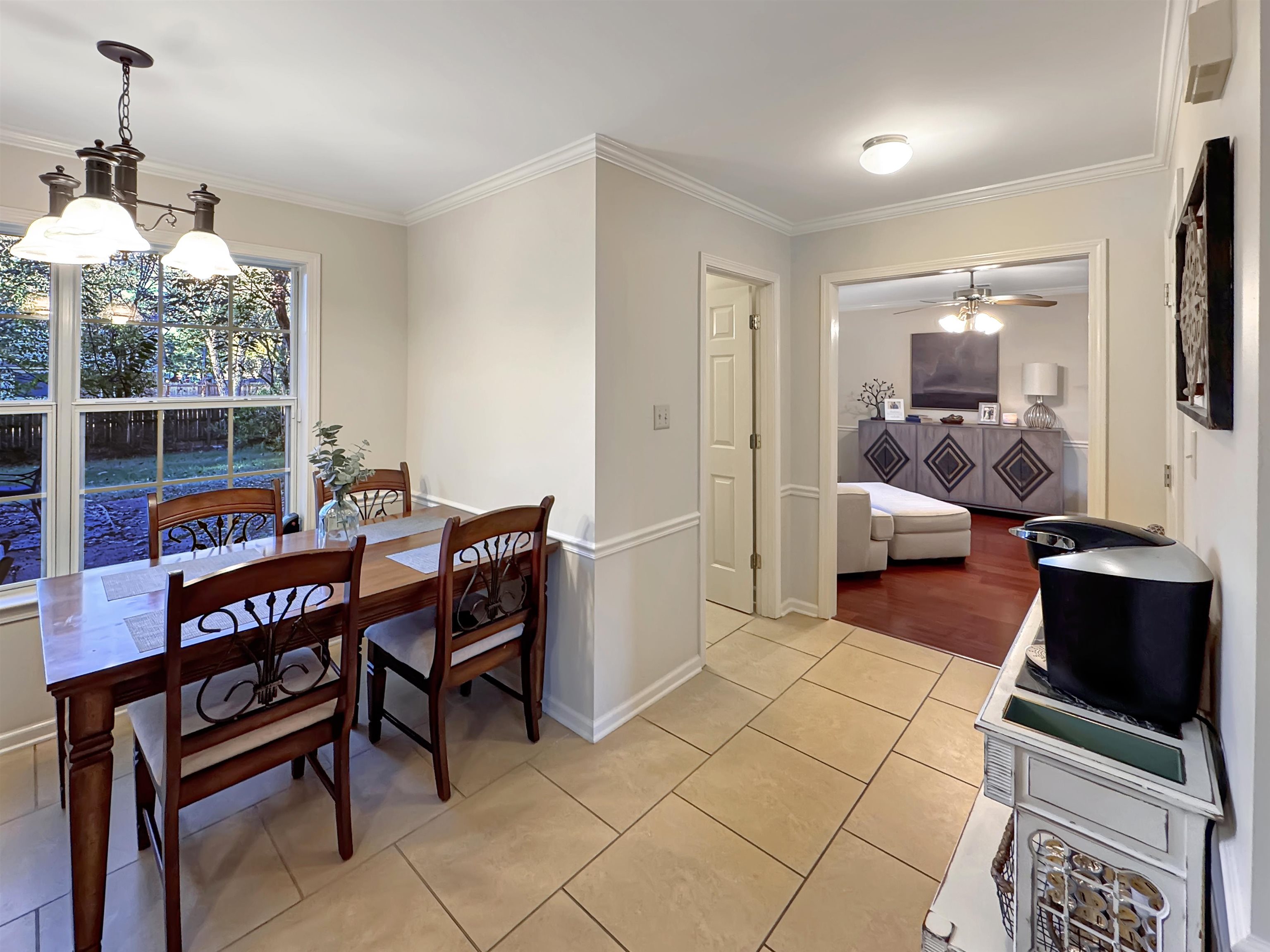 340 Scarlett's Way Collierville, TN 38017 - Photo 8 of 40 Dining room with ornamental molding, light tile patterned flooring, ceiling fan, and a chandelier