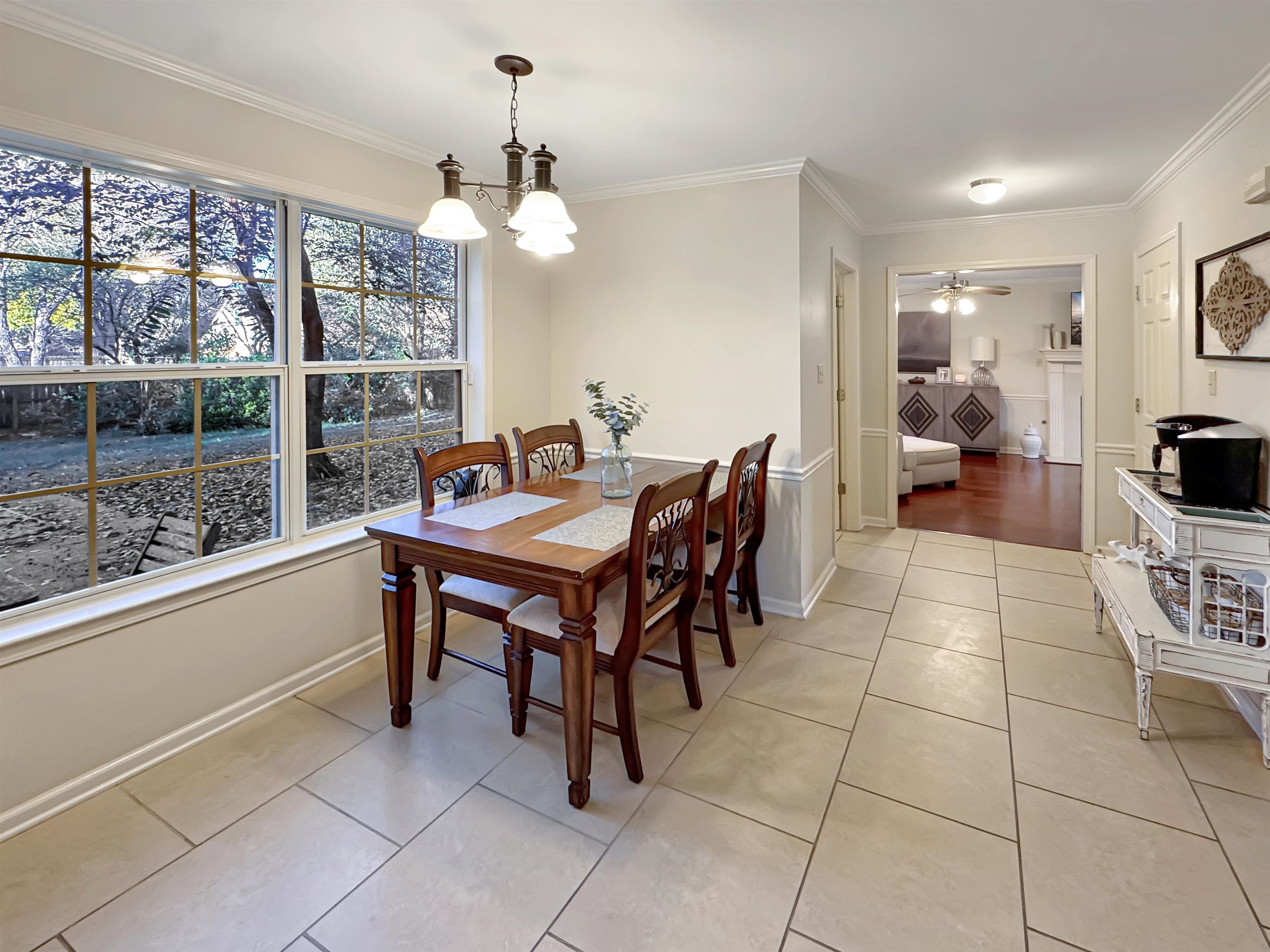 340 Scarlett's Way Collierville, TN 38017 - Photo 9 of 40 Dining space featuring crown molding, light tile patterned floors, a ceiling fan, and a chandelier