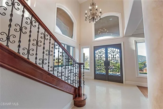 a living room with furniture fireplace and a large window