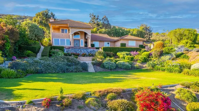 an aerial view of a house with a yard and garden