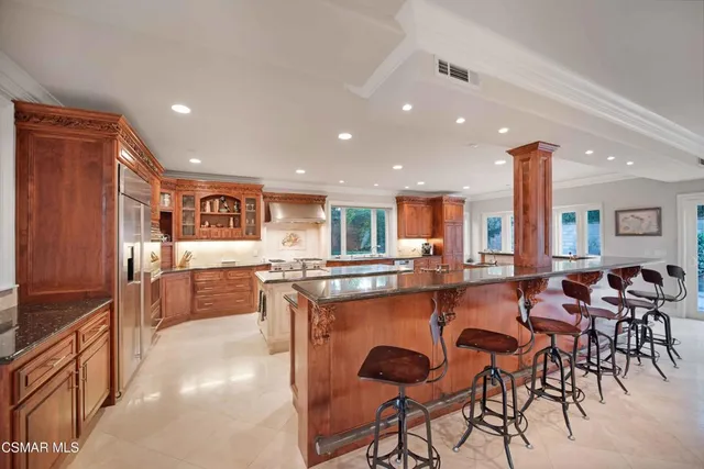 a kitchen with stainless steel appliances granite countertop a stove and a sink