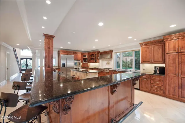 a large living room with furniture large windows and a fireplace