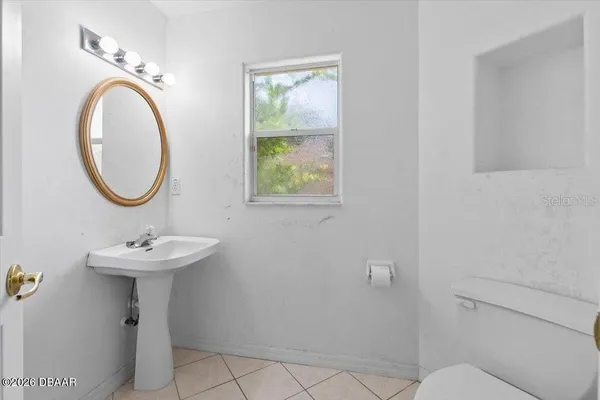 a bathroom with a sink a mirror and a toilet