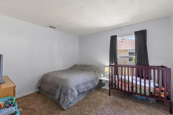 a bed sitting in a room next to a window