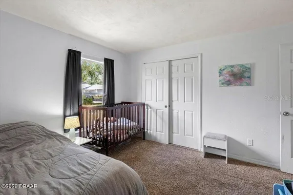 a view of a bedroom with furniture and windows