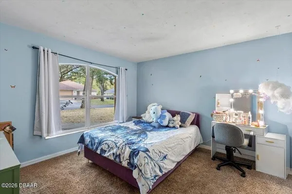 a bedroom with a bed chair and window