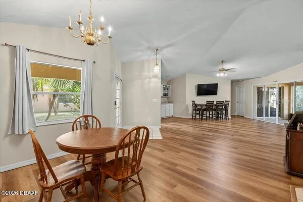 a view of a dining room with furniture window and wooden floor